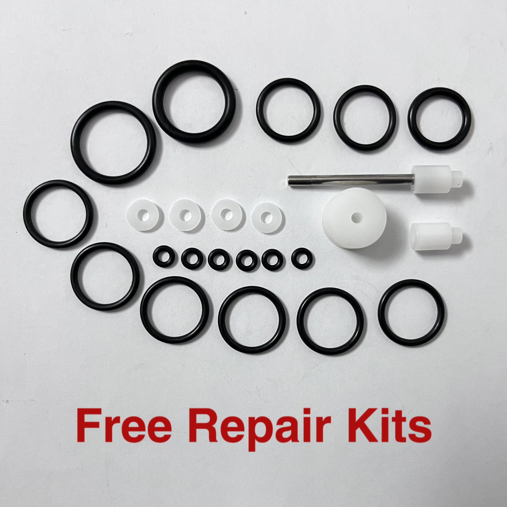 Collection of black and white repair parts on a white background with 'Free Repair Kits' text.